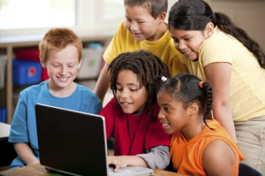 young students around a computer