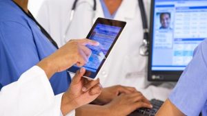 A group of physicians working on a tablet