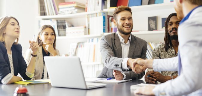 A group meeting and shaking hands