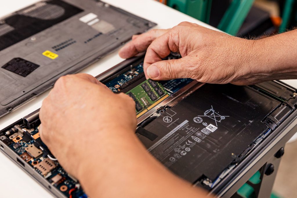 Man installing chip in laptop