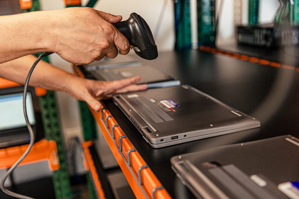 Man inventorying laptop