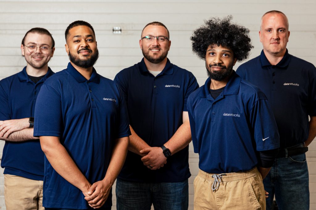 5 men smiling at camera