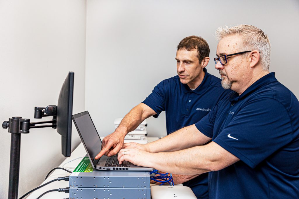 2 men working on computer