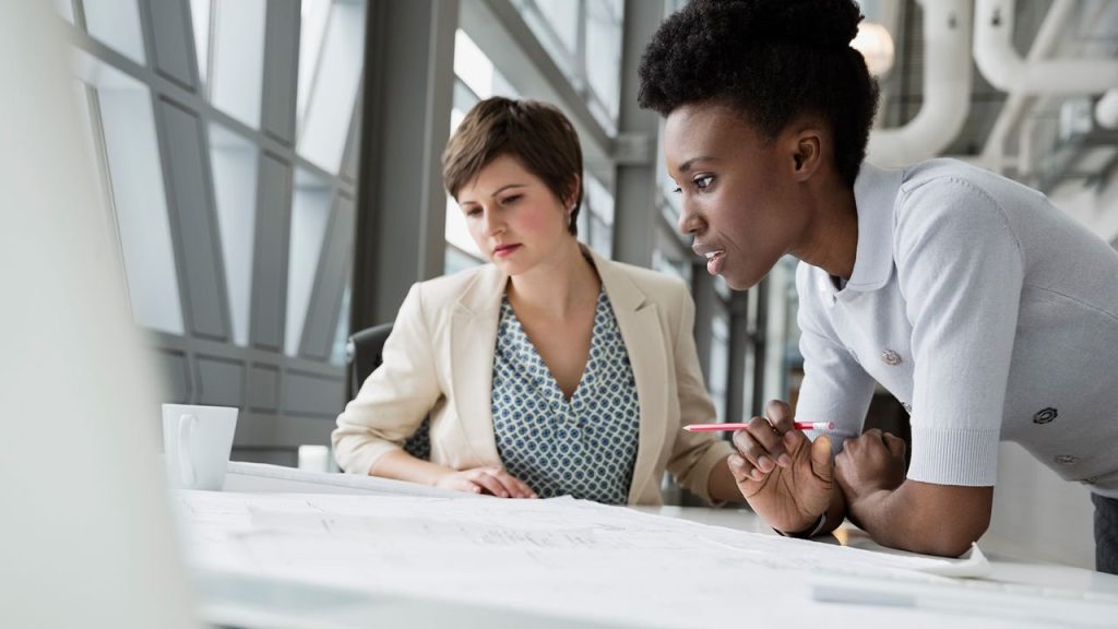 Two people looking at contracts