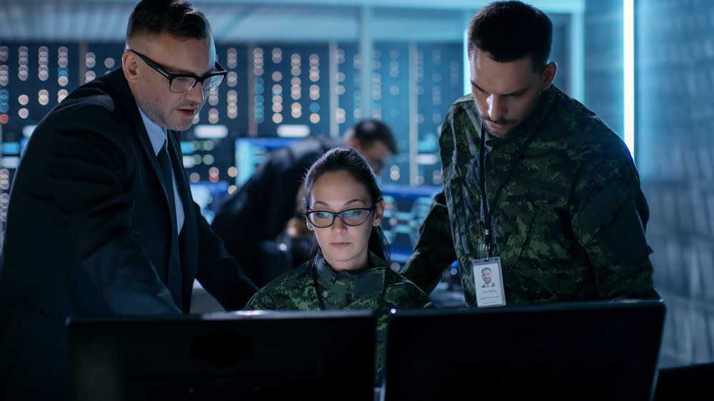 military personnel around a computer