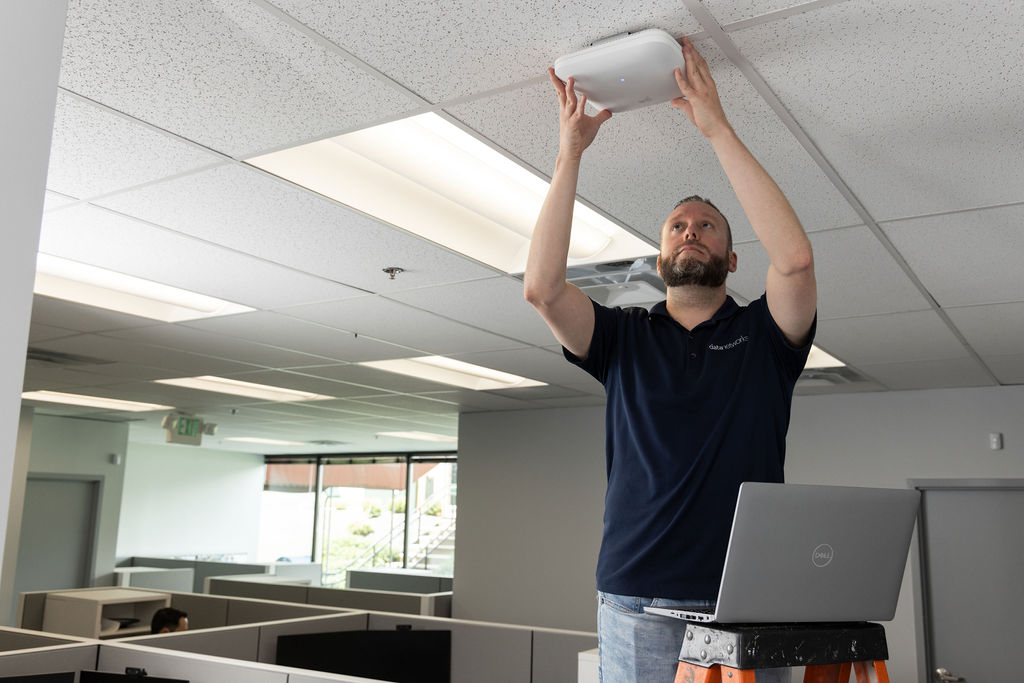 Engineer installing an access point