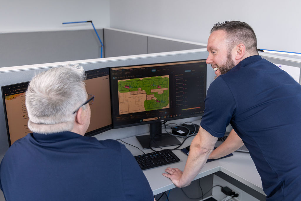 Two men working on credential authentication project