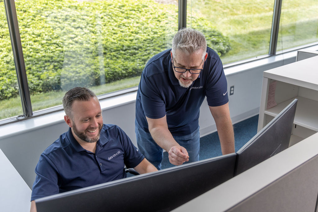 Two engineers working on IP migration
