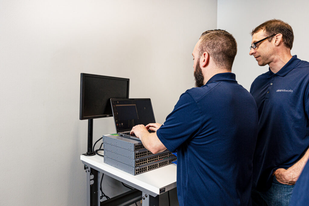 Man installing a network switch and network management