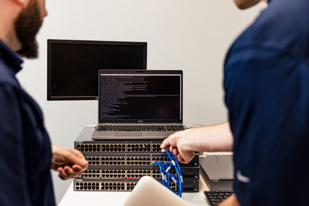 Two men installing a Juniper firewall