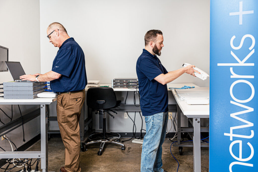 Two men performing a network upgrade