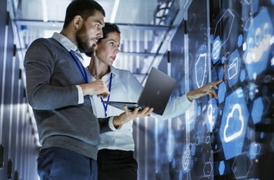 Two people working in a data center
