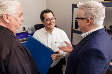 3 men discussing a switch