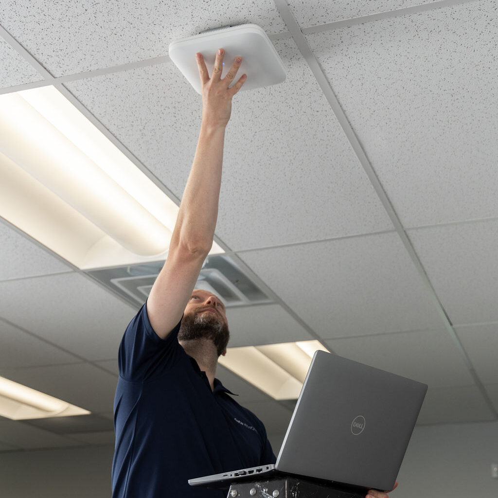 engineer completing wireless network upgrade